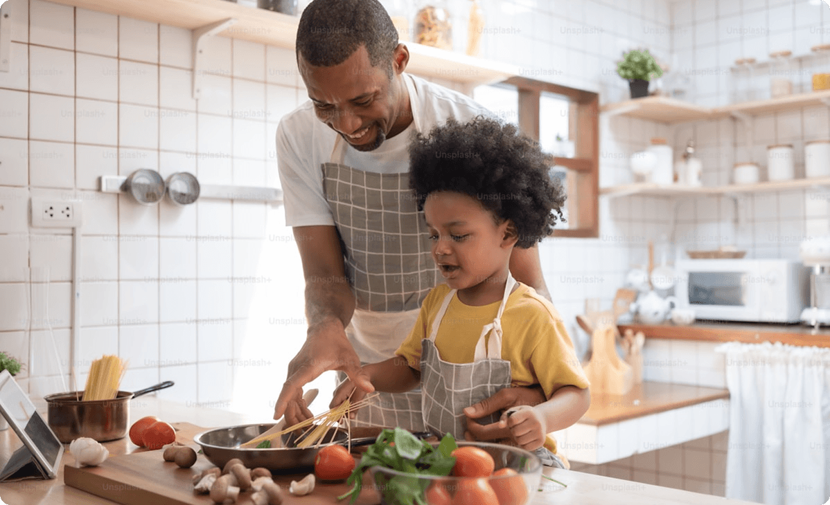 father and child cooking